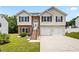 Charming two-story house with brick accents, a manicured lawn, and a two-car garage at 1543 Blossom Dr, Atlanta, GA 30349