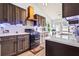 Well-lit kitchen with modern countertops, stainless steel appliances, mosaic backsplash, and wood-look floors at 1543 Blossom Dr, Atlanta, GA 30349