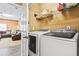 Convenient laundry room featuring modern washer and dryer set with shelving for ample storage at 1543 Blossom Dr, Atlanta, GA 30349