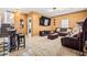 Spacious living room with a leather sofa, bar area, and stairs to the second level at 1543 Blossom Dr, Atlanta, GA 30349