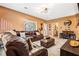 Inviting living room with a plush leather sectional, stylish bar area, and neutral carpeting at 1543 Blossom Dr, Atlanta, GA 30349