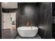 Modern bathroom featuring black marble, gold fixtures, and a free-standing tub at 1721 S Gordon Sw St, Atlanta, GA 30310