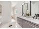 Modern bathroom featuring a double sink vanity, marble floors and a view of the walk-in closet at 1721 S Gordon Sw St, Atlanta, GA 30310