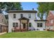 Charming two-story home featuring a welcoming front porch and manicured lawn on a sunny day at 1721 S Gordon Sw St, Atlanta, GA 30310