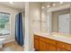Well-lit bathroom featuring a large vanity, tile floors, and a shower-tub combination for convenience and comfort at 3547 Edenridge Ct, Buford, GA 30519