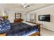 Comfortable bedroom featuring neutral walls, a ceiling fan, and a mounted television for relaxing entertainment at 3547 Edenridge Ct, Buford, GA 30519