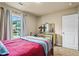 Bright bedroom features a large window, neutral walls and carpet, and a vintage-style bed frame with lamps at 3547 Edenridge Ct, Buford, GA 30519
