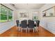 Elegant dining room with a chandelier, hardwood floors, and wainscoting at 3547 Edenridge Ct, Buford, GA 30519