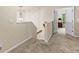 Bright hallway with plush carpet leading to a room with an open double door and a hanging light fixture at 3547 Edenridge Ct, Buford, GA 30519