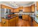 Well-equipped kitchen featuring stainless steel appliances, dark countertops, and ample wood cabinetry for storage at 3547 Edenridge Ct, Buford, GA 30519