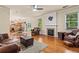 Open-concept living room with hardwood floors, fireplace, and seamless flow to the kitchen at 3547 Edenridge Ct, Buford, GA 30519