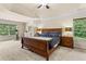 Spacious main bedroom boasts a trey ceiling, large windows, and an exercise bike for a healthy lifestyle at 3547 Edenridge Ct, Buford, GA 30519