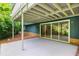 Back patio under a deck with a concrete surface and sliding doors to the interior at 3861 Foxford Dr, Atlanta, GA 30340