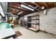 Unfinished basement area with exposed ceiling, shelving, and two stainless steel refrigerators at 3861 Foxford Dr, Atlanta, GA 30340