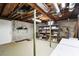 Unfinished basement space with exposed ceiling, block walls, shelving, and support beams at 3861 Foxford Dr, Atlanta, GA 30340