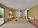 Furnished basement featuring brick wall, cabinet, and walk-out doors to the exterior at 3861 Foxford Dr, Atlanta, GA 30340