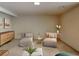 Staged basement with lounge chairs, modern storage cabinet, and stylish decor at 3861 Foxford Dr, Atlanta, GA 30340