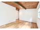 Airy bedroom features hardwood floors, wood plank ceiling, and a large window at 3861 Foxford Dr, Atlanta, GA 30340