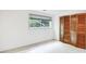 Bedroom featuring a window with shade and a wooden bi-fold door closet for easy access at 3861 Foxford Dr, Atlanta, GA 30340