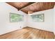 Bright bedroom boasts hardwood floors, wood ceiling, and natural light from windows at 3861 Foxford Dr, Atlanta, GA 30340