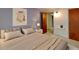 Comfortable bedroom with purple walls, a large bed, side table, and doorway access at 3861 Foxford Dr, Atlanta, GA 30340
