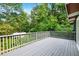 Expansive wooden deck with railing, offering a relaxing outdoor space surrounded by lush greenery and trees at 3861 Foxford Dr, Atlanta, GA 30340