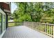 A spacious wooden deck showcasing scenic views of surrounding trees and outdoor living space at 3861 Foxford Dr, Atlanta, GA 30340