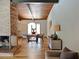 Open dining area features wood floors, a brick fireplace, and a view into the cozy living space at 3861 Foxford Dr, Atlanta, GA 30340