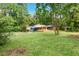 Spacious front yard with mature trees and a single story home with a convenient carport for parking at 3861 Foxford Dr, Atlanta, GA 30340