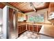 Well-lit kitchen featuring wooden cabinetry, stainless steel refrigerator and tile flooring at 3861 Foxford Dr, Atlanta, GA 30340