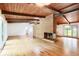 Large living room features hardwood floors and exposed beam ceiling at 3861 Foxford Dr, Atlanta, GA 30340