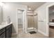 Modern bathroom with glass-enclosed shower, single vanity and neutral tones at 1603 Glen Ivy, Marietta, GA 30062
