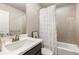 Well-lit bathroom features a tub/shower combo with tiled surround at 1603 Glen Ivy, Marietta, GA 30062