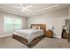 Comfortable bedroom with a ceiling fan, natural light, and a wood-framed bed at 1603 Glen Ivy, Marietta, GA 30062