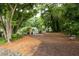 Beautifully landscaped common area with mature trees, seating, and a gated entrance for added privacy at 1603 Glen Ivy, Marietta, GA 30062
