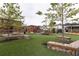 An open community space offers wooden benches, green turf, and mature trees, creating a gathering spot at 1603 Glen Ivy, Marietta, GA 30062