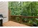 Enjoy nature on this outdoor deck with a grill, surrounded by lush greenery for peaceful relaxation at 1603 Glen Ivy, Marietta, GA 30062