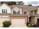 Charming townhome featuring a two-car garage and a mix of brick and siding at 1603 Glen Ivy, Marietta, GA 30062