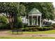A picturesque park gazebo is framed by flowering trees and manicured shrubs, creating a peaceful retreat at 1603 Glen Ivy, Marietta, GA 30062