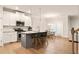 Spacious kitchen featuring a center island with seating, stainless appliances, and hardwood floors at 1603 Glen Ivy, Marietta, GA 30062