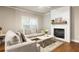 Bright living room features neutral tones, hardwood floors, a modern fireplace and large window at 1603 Glen Ivy, Marietta, GA 30062