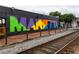 Colorful mural of 'Marietta' on a building near railroad tracks, showcasing local art at 1603 Glen Ivy, Marietta, GA 30062