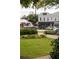 Lush greenery surrounds a quaint sidewalk in this vibrant street view featuring shops and restaurants at 1603 Glen Ivy, Marietta, GA 30062