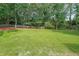 This expansive backyard features a lush lawn, mature trees, and privacy fencing at 2970 Chardonnay Ln, Cumming, GA 30041