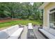 View of a backyard from the deck with outdoor furniture, lawn, and trees at 2970 Chardonnay Ln, Cumming, GA 30041