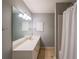 Well-lit bathroom featuring a large mirror, single sink vanity, and shower with curtain at 2970 Chardonnay Ln, Cumming, GA 30041