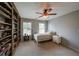 Cozy bedroom featuring built-in shelves, neutral walls, and a ceiling fan at 2970 Chardonnay Ln, Cumming, GA 30041