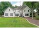 Two-story stucco home with stone accents, manicured lawn, and lush green landscaping at 2970 Chardonnay Ln, Cumming, GA 30041