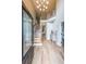 Grand foyer with hardwood floors, staircase, chandelier, and lots of natural light at 2970 Chardonnay Ln, Cumming, GA 30041