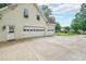 Three-car garage with driveway and basketball hoop at 2970 Chardonnay Ln, Cumming, GA 30041